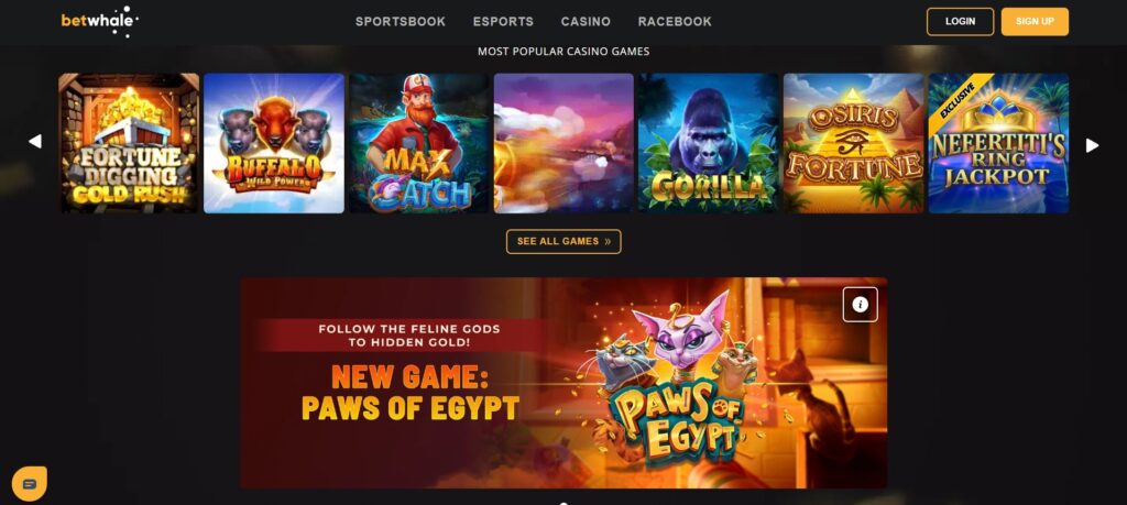 Screenshot of the Betwhale online casino homepage showing top navigation links for Sportsbook, Esports, Casino, and Racebook, a login and sign up area, a Most Popular Casino Games grid with thumbnails for Fortune Digging Gold Rush, Buffalo Wild Power, Max Catch, Gorilla, Osiris Fortune, and Exclusive Nefertiti's Ring Jackpot, plus a Paws of Egypt promotional banner inviting players to follow the feline gods to hidden gold.
